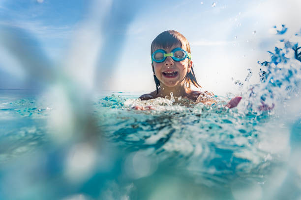 istock Smiling boy swims in the sea 1216865909