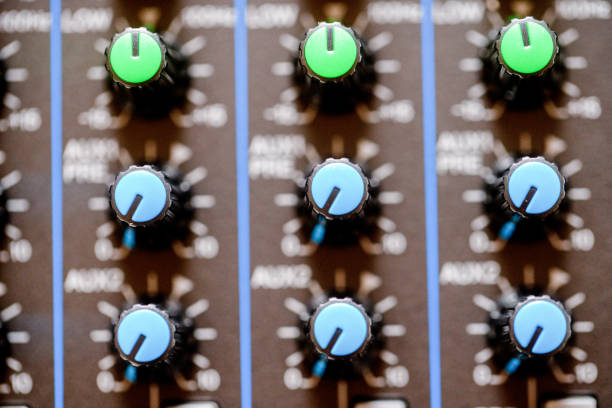 A close-up shot of a modern digital sound mixing console