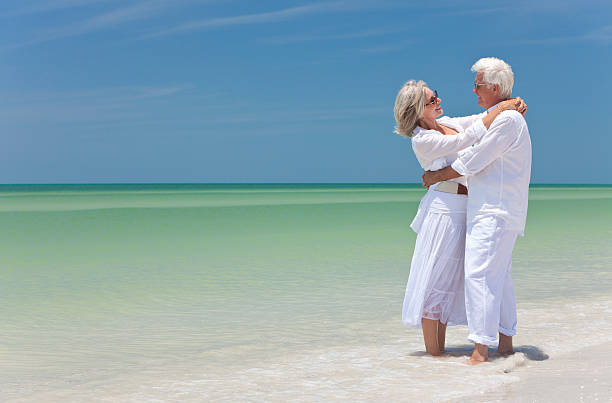 istock Happy Senior Couple Embracing on A Tropical Beach 121686794