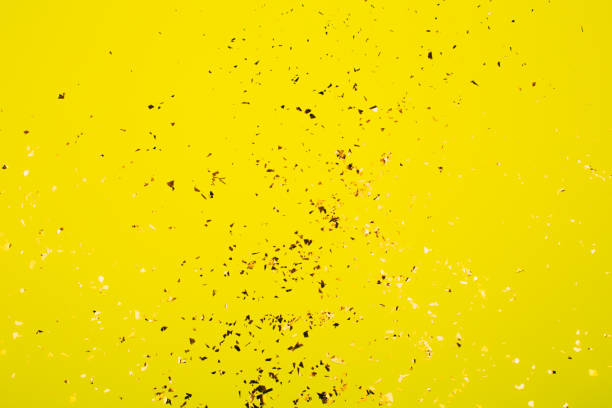 istock Golden flying sparkles on bright yellow background. 1216869447