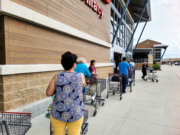 Waiting in Long Lines at HEB Grocery Store due to Pandemic Scare. stock photo