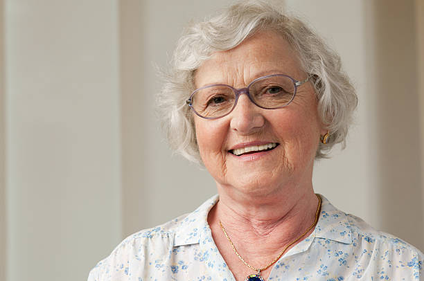Smiling senior woman closeup Happy smiling senior woman looking at camera at home. 80 89 years stock pictures, royalty-free photos & images