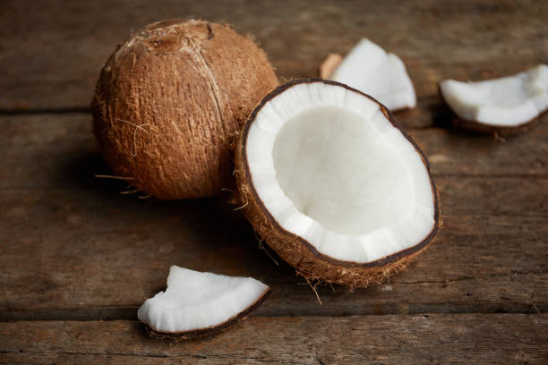 istock Fresh organic coconut on rustic wooden background 1216871520