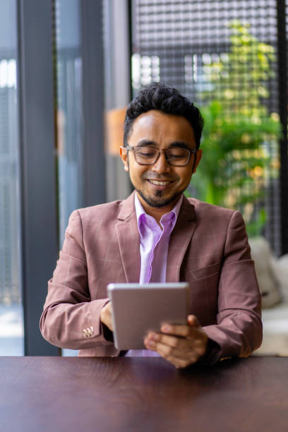 istock Asian Malay businessman working with digital tablet. 1216874512
