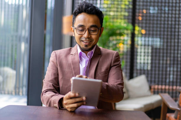 istock Asian Malay businessman working with digital tablet. 1216874513