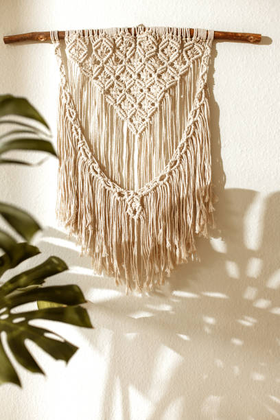 istock Handmade macrame on the wall with monstera plant and shadow 1216874560