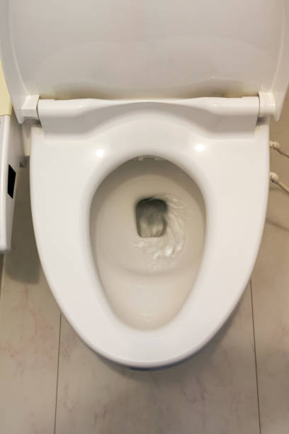 istock Toilet bowl with flowing water 1216884691