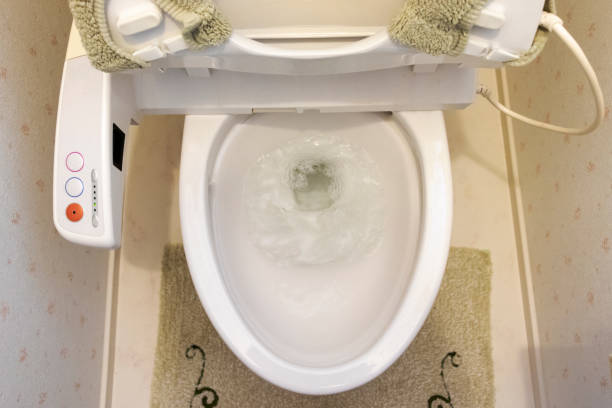 istock Toilet bowl with flowing water 1216884706