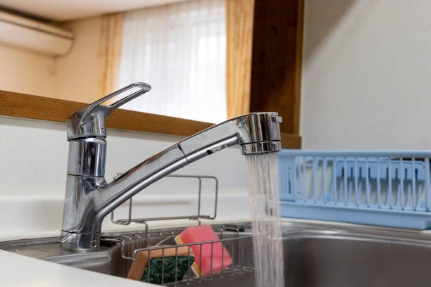 istock Water flowing from kitchen faucet 1216884727