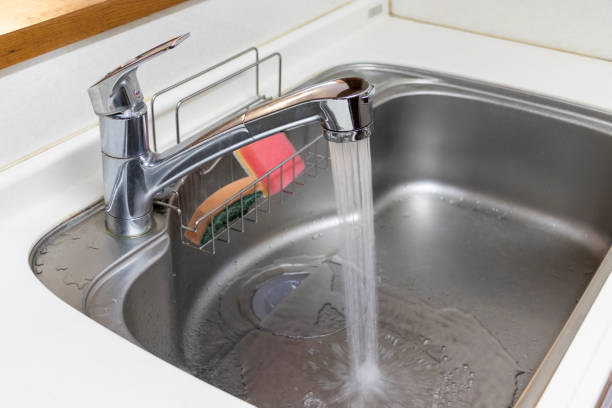 istock Water flowing from kitchen faucet 1216884728