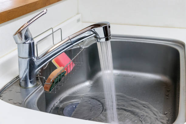 istock Water flowing from kitchen faucet 1216884730