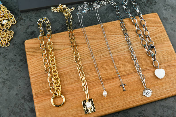 istock precious chains on a light wooden background. chains on wooden background. View from above 1216890698