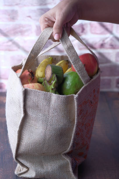 istock Young man holding grocery shopping bag with vegetables 1216890814