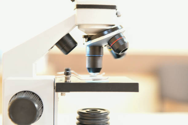 istock Microscope close-up. shot of microscope with metal lens with abstract with points, lines, and shapes 1216891571
