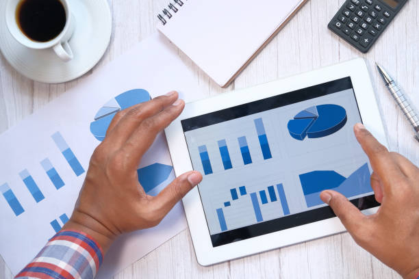istock Close up of man hand analyzing chart on digital tablet 1216891661