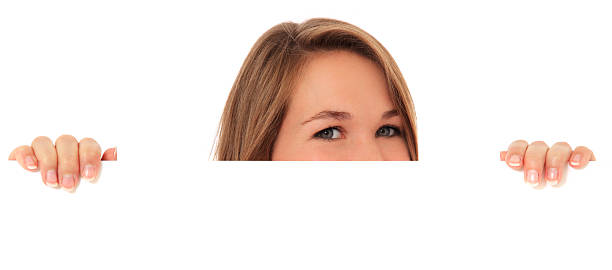 istock Young woman curious looking behind white wall 121689471