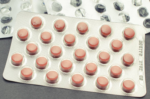 istock Full and empty pill blister on black background. Medicine concept 1216899429