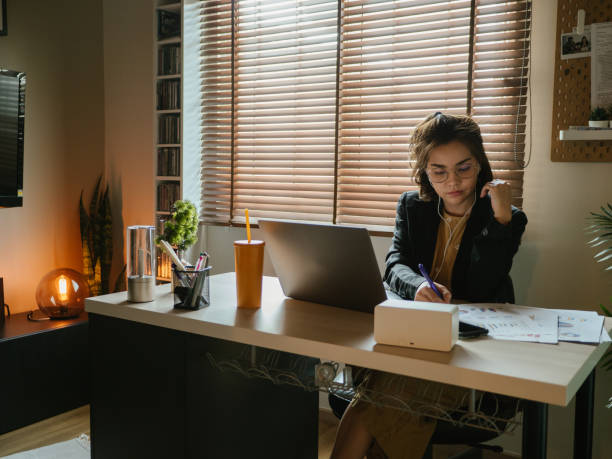istock Asian woman using laptop during conference call at home. 1216902337