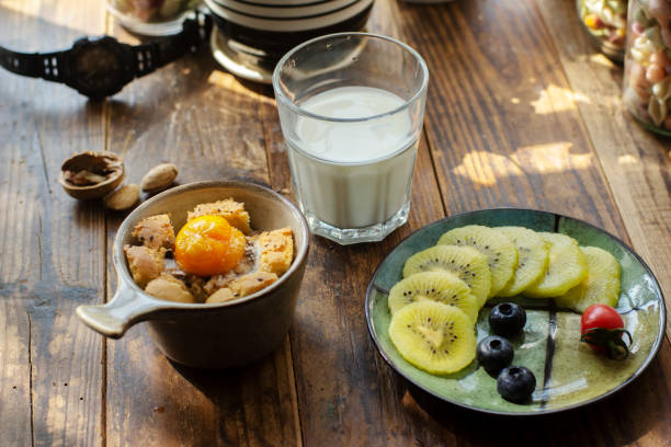 istock homemade breakfast: toasted egg in bread cup, fresh fruits and milk 1216908889