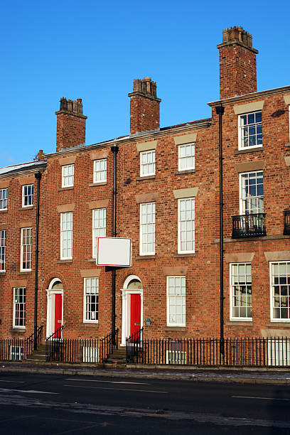 istock Typical british houses with blank sign 121690919