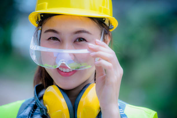 istock Portrait worker woman Industry wearing causal  uniform, smile face standing on control operating machine work in industry factory. 1216909336