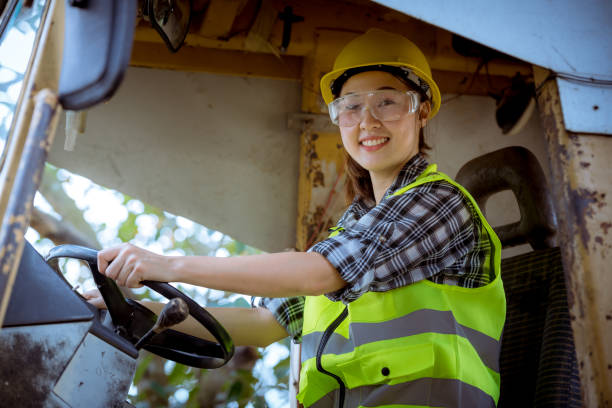 istock Portrait worker woman Industry wearing causal  uniform, smile face standing on control operating machine work in industry factory. 1216909414