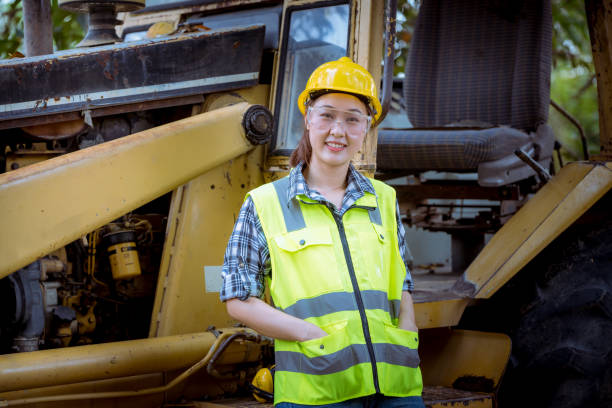 istock Portrait worker woman Industry wearing causal  uniform, smile face standing on control operating machine work in industry factory. 1216909417