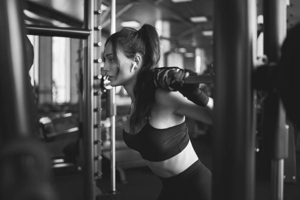 istock Woman training in smith machine, monochrome. 1216909512