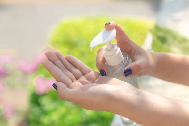 istock Female hands using wash hand sanitizer gel pump dispenser. 1216910335