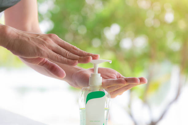 istock Female hands using wash hand sanitizer gel pump dispenser. 1216910350