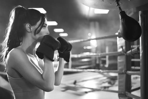 istock Woman hitting small punching bag, monochrome. 1216910426