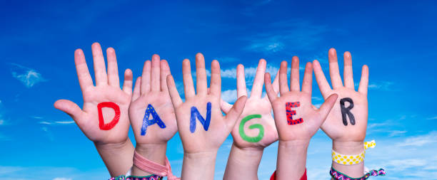 istock Children Hands Building Word Danger, Blue Sky 1216911271
