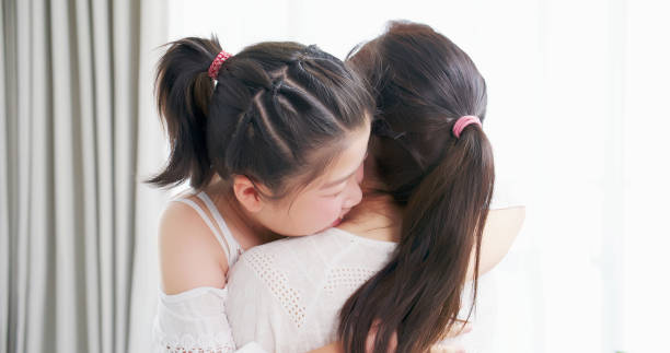 istock daughter give mom a hug 1216911620
