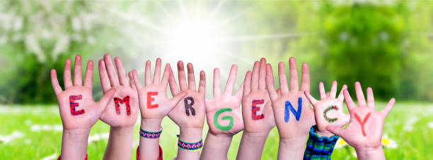 istock Children Hands Building Word Emergency, Grass Meadow 1216911703