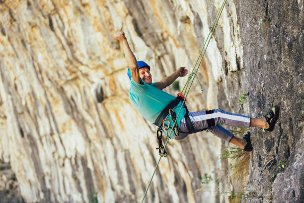 istock Senior man with a rope climbing on the rock. 1216911723