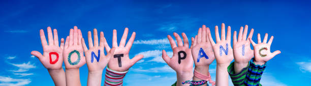 istock Kids Hands Holding Word Do Not Panic, Blue Sky 1216912631