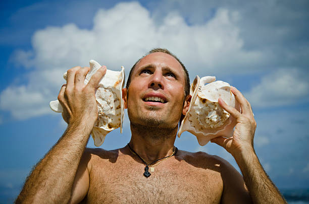 istock Man listening to Sea Shells 121691497