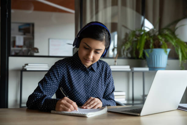 istock Concentrated female student studying remotely on online courses. 1216915024