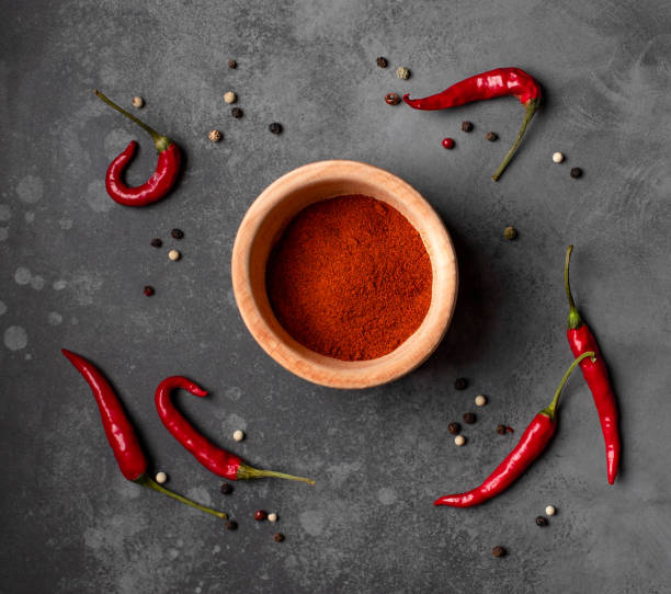 istock different types of pepper on a dark background. 1216915268