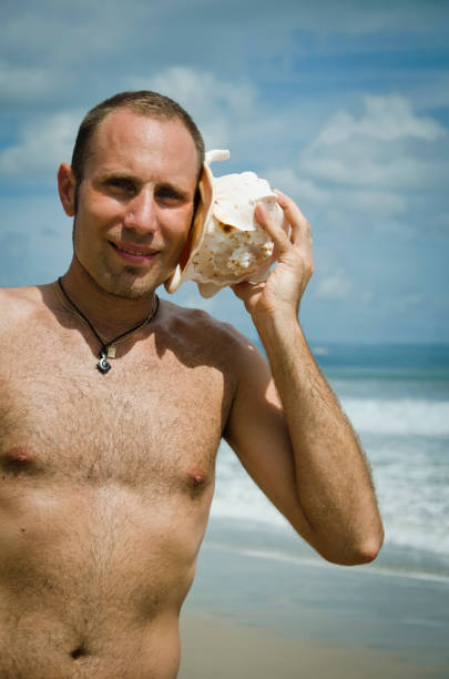 istock Man listening to a Sea Shell 121691531