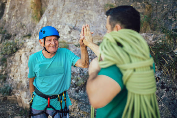 istock Senior climber with climbing equipment, preparing for climbing. 1216915409