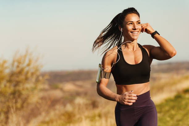 istock Happy female athlete enjoying while jogging during sports training in nature. 1216916655