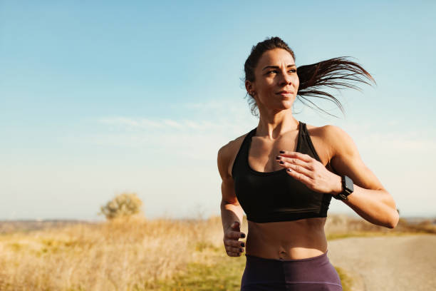 istock Determined muscular build woman running while exercising in nature. 1216916752