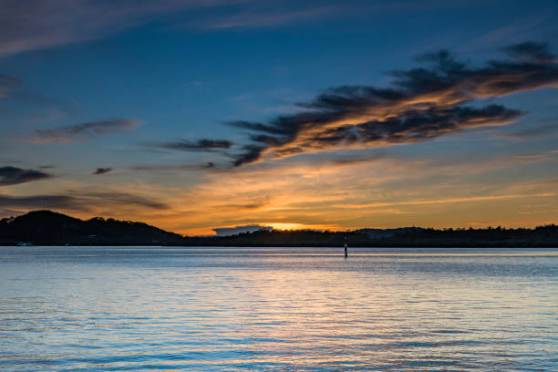 istock Sunrise Waterscape over the Bay with High Clouds 1216917857