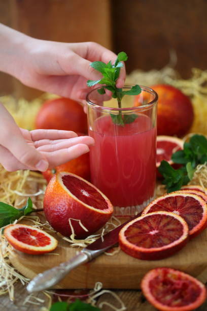 istock Still life with red oranges and lemons on a wooden background 1216922583