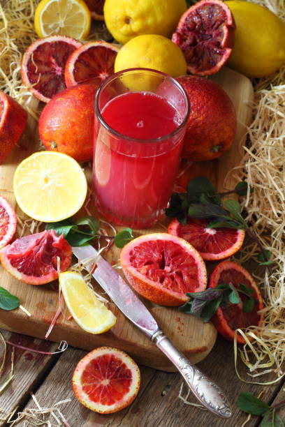 istock Still life with red oranges and lemons on a wooden background 1216922705