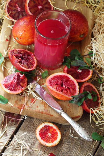istock Still life with red oranges and lemons on a wooden background 1216922933