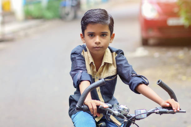 istock Indian little boy enjoying the cycle ride 1216924241