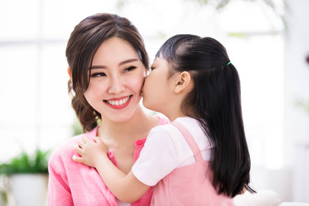 istock Daughter kiss mom tenderly 1216924361