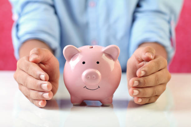 istock Boy holding piggy bank for savings 1216924481